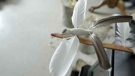 John Pingayak carving a bird out of wood for his grandchildren. (National Geographic/Matt Kynoch)
