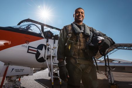 Portrait of student Captain Micah Nissly next to a T-45. (Credit: National Geographic/Freddie Claire)