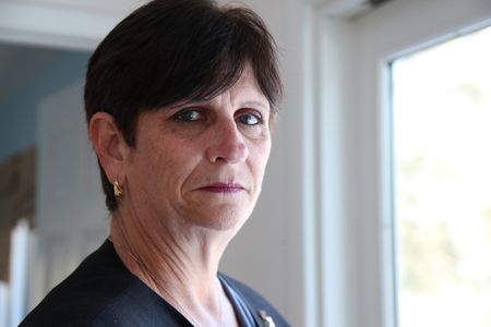 9/11: ONE DAY IN AMERICA - Kathy Comerford, head of events for Morgan Stanley, was attending a meeting on the 70th floor of the South Tower when the first plane hit. (National Geographic/Daniel Bogado)