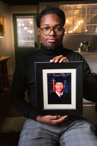 Braylon Brown, nephew of Fulton County John Doe David Brown, holds David's graduation picture. (National Geographic/Tom Beard)