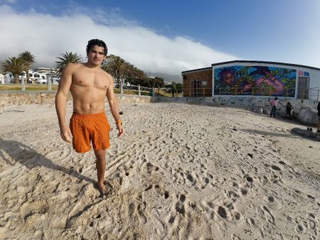 Caleb Swanepoel on Camps Bay Beach, Cape Town. (National Geographic/Robert Cowling)