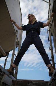 Mariana van Zeller stands between two trains in Culiacán, Mexico. (National Geographic)