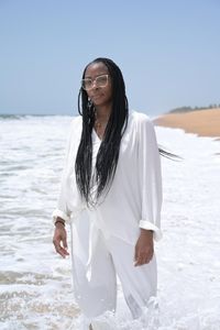 Altevese Rosario stands resolutely on Ouidah Beach, the first stop in her reverse journey through Benin to symbolically return her ancestor, Cudjo 'Kossola' Lewis, home. (National Geographic/Etinosa Yvonne)