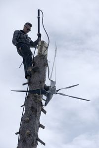 Joel Jacko installs a windmill on his property for additional power. (National Geographic/Wayne Shockey)