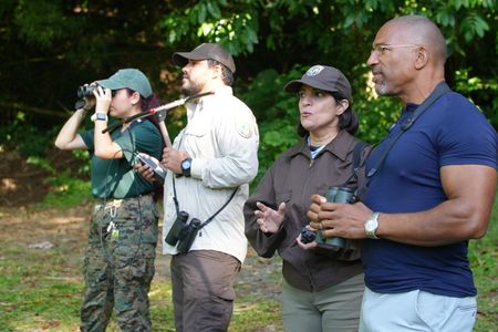Christian Cooper observes the historic release of 7 Puerto Rican Parrots into the wild with Marisel López-Flores Lopez, the Project Leader of the Puerto Rican Parrot Recovery Program. (National Geographic for Disney)