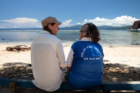 Dr. Crissy Huffard, left, discussing Algae octopus (Abdopus aculeatus) with her friend and Bunaken resident, Tante Ita, on the shores of Bunaken Island.(photo credit: National Geographic/Annabel Robinson)