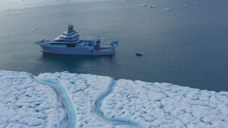 The OceanXplorer is off-shore from a Svalbard glacier. (National Geographic)