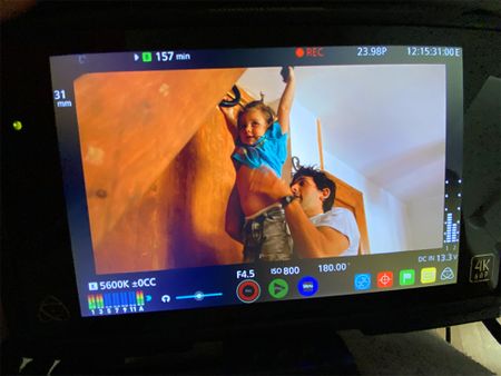 The camera monitor shows Gerd Serrasolses lifting his son Rio into the air.  (National Geographic/Gene Gallerano)