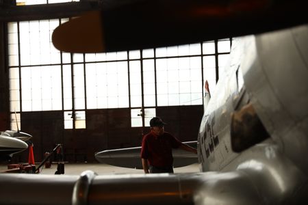 Tuskegee Airman LT. COL. (RET) Harry T. Stewart stands next to a WWII restored Mustang airplane at The Tuskegee Airmen National Museum in Detroit. (National Geographic/Rob Lyall)