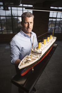 Chris Hearn stands with a model of RMS Titanic. (National Geographic/Freddie Claire)