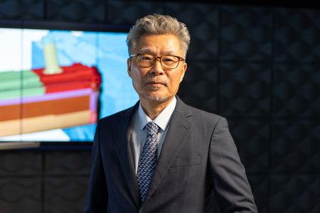 Jeom Kee Paik stands in front of a simulation of the Titanic. (National Geographic/Gary Moyes)