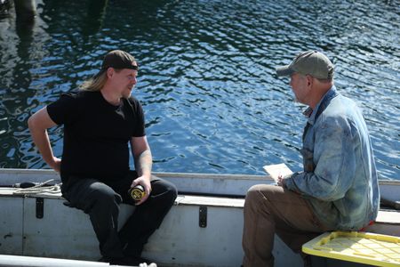 David Squibb and Sam Carlson take measurement's of Squibb's skiff, ahead of constructing a new fairlead for the boat. (National Geographic/Wayne Moss)