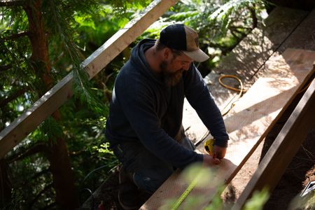 Carl Hernandez helps construct a ramp on his neighbor's property. (National Geographic/Mickey Ramos)