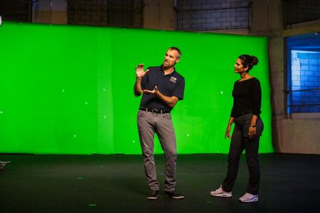 Mike Heithaus demonstrating shark jaws to Diva Amon during take at studio lab shoot. (National Geographic/Aubrey Fagon)