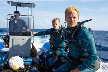Captain, Paulo Gaspar, steering the rib with Underwater cameraman, Jeff Hester and host, Bertie Gregory, to the next dive site. (credit: National Geographic/Adam Boyle)