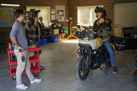 Tom Barbor-Might, left, works behind the scenes as Craig Hemsworth puts on his helmet during production of "Chris Hemsworth: A Road Trip to Remember" in Australia. (credit: National Geographic/Craig Parry)