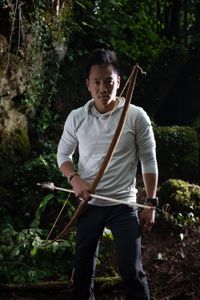 Coleford, UK - Albert Lin with bow and arrow. (National Geographic/Hugh Campbell)