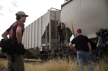 Mariana van Zeller and film crew stand around trains in Culiacán, Mexico. (National Geographic)