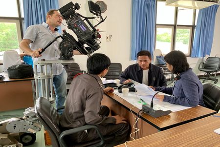 A reenactment of a group of people conducting research on the students who took the Embassy of Myanmar in Central Bangkok under siege in 1999. (©2019 MCN International Pte Ltd. All Rights Reserved.)