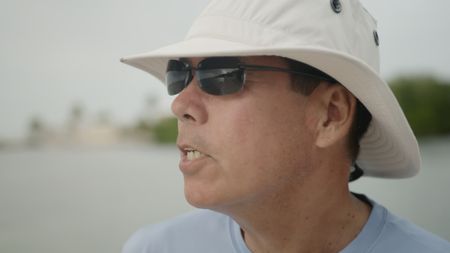 Dr. Stephen Kajiura driving a boat in Fort Lauderdale, Florida. (National Geographic)