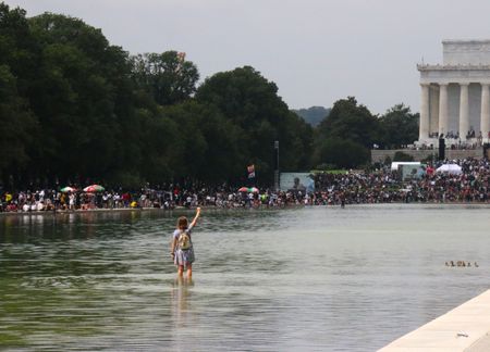 Young woman holds up fist at the 2020 March on Washington. (National Geographic/Drew Jones)