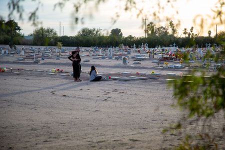 Joseph Robin, Michelle Harrison, and Tajia Robin visit Melody Harrison's grave. (National Geographic/Tom Beard)