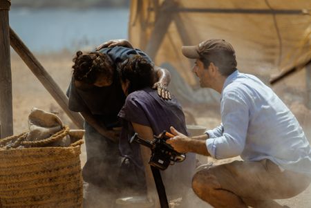 Tom Barbor-Might (Director, Showrunner, EP) coaches the supporting artists at the Pompeii displacement camp, behind-the-scenes of Pompeii: Out of Time with Tom Hiddleston. (National Geographic/Darrin Zammit Lupi)