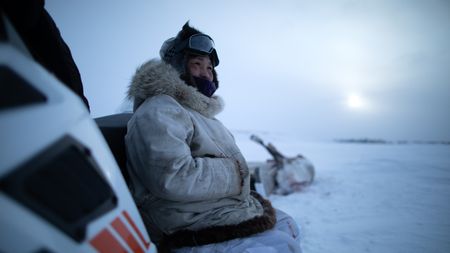 Agnes Hailstone waits for her husband, Chip Hailstone while he peruses a herd of caribou. (BBC Studios Reality Productions, LLC/Ashton Hurlburt)