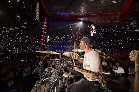 Chris Hemsworth drums during the Ed Sheeran concert in Bucharest. (credit: National Geographic/Evan Paterakis)