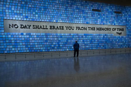 Bill Spade stands in front of the memorial wall at the 9/11 Memorial & Museum. (National Geographic/Virginia Sherwood)
