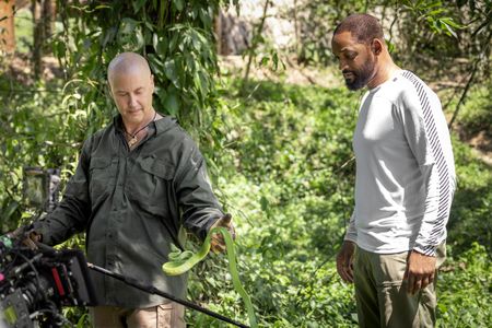 Professor of Toxicology Bryan Fry shows Will Smith a snake while they are in the Ecuadorian rainforest. (credit: National Geographic/Kyle Christy)