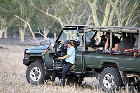 Sue Gibson films from a car on a RED with a long lens. Director Matthew Underwood watches from the car. (National Geographic/Virginia Quinn)