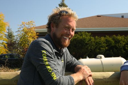 Ren Reinhold smiles while leaning against a fence at the Pol family's farm. (National Geographic)