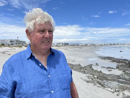 Charles Maxwell on the beach. (National Geographic/Robert Cowling)