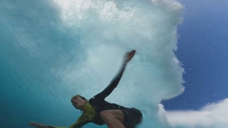 Justine Dupont looks up as she surfs a wave that is curling above her.  (Mandatory photo credit: Justine Dupont)