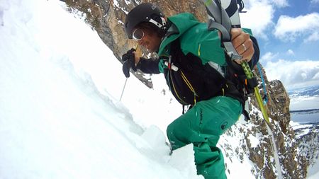 Holding poles, Jeremy Jones climbs a mountain covered in snow in the Teton range, Wyoming.  (credit: Teton Gravity Research)