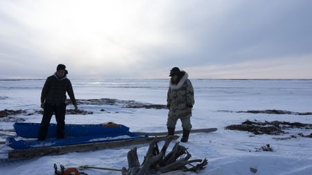 John Pingayak and his grandson, John "Sonna Boy" Pingayak III cut and gather wood. (National Geographic/Matt Kynoch)