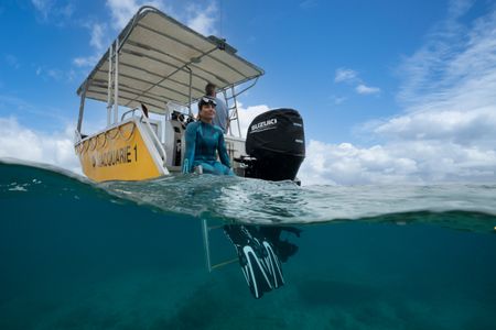 Dr. Alex Schnell on the stern of a Lizard Island Research Station dive vessel, prior to diving with Day octopus (Octopus cyanea) on the Great Barrier Reef.  (photo credit: National Geographic/Craig Parry)