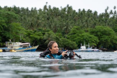 Dr. Alex Schnell surfaces after a dive observing Coconut octopus (Amphioctopus marginatus) on the Lembeh Strait. (National Geographic for Disney/Craig Parry)