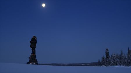 Tig Strassburg looks for wolf signs in the nearby wilderness. (National Geographic)