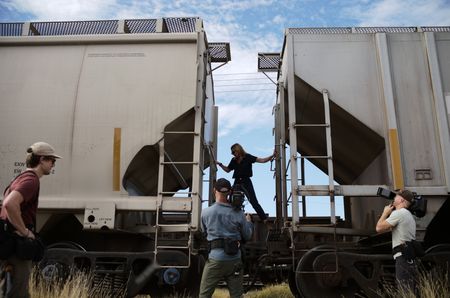 Mariana van Zeller and film crew stand around trains in Culiacán, Mexico. (National Geographic)
