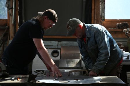 David Squibb and Sam Carlson construct a new fairlead for Squibb's skiff. (National Geographic/Wayne Moss)