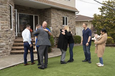 The D'Allara family and the Spade family hug during their reunion. (National Geographic/Virginia Sherwood)