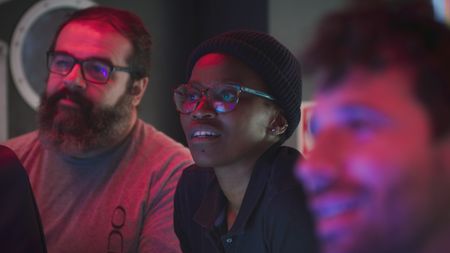 OceanXplorer's Science and information technology officer Carlos Fonseca is with Zoleka Filander and Eric Stackpole in the ROV control room observing the sixgill sharks interact with the submersibles as they pass through a shoal of boarfish. (National Geographic)