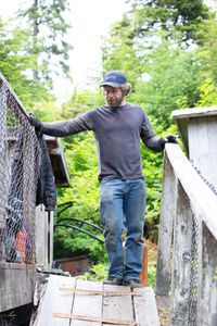 Matt Carlson helps repair a gangway. (National Geographic/Wes Waters)