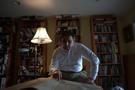 Syed Hashmi looks at a map while at home in Westborough, MA. Hashmi is Akbar Khanìs eldest great grandchild. Major Akbar Khan was the most senior Indian in the British Army during WW2 and a member of Force K6, a little known Indian regiment of mule handlers. Amidst the chaos of Dunkirk and the advancing German Army, the Indian regiment fought for victory and independence. (National Geographic/Daniel Dewsbury)