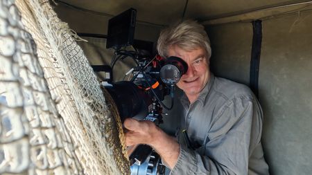 Cinematographer John Aitchison films from a hide. (National Geographic)