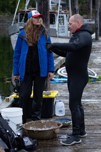 Sarah McDonald assists Troy Brockway as he scuba dives, searching for potential helpful sunken treasures. (National Geographic/Kelly Robertson)
