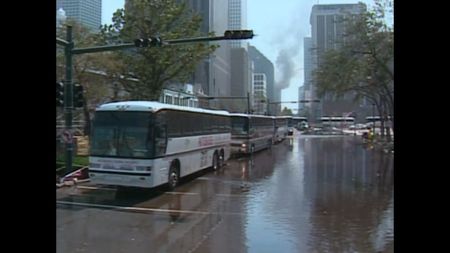 Buses line up on a flooded street in New Orleans, procured to evacuate residents following Hurricane Katrina in 2005. (CNN)