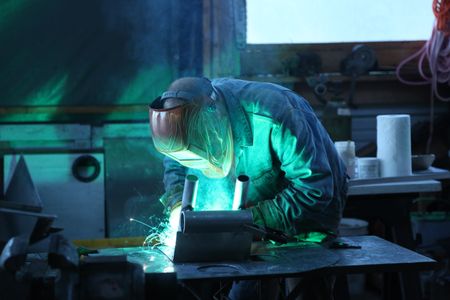 Sam Carlson constructs a new fairlead for his friend's skiff. (National Geographic/Wayne Moss)